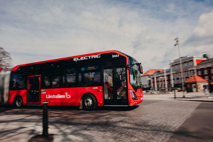 Bild på en röd stadsbuss i Jönköping centrum, hållplats Rådhusparken. 